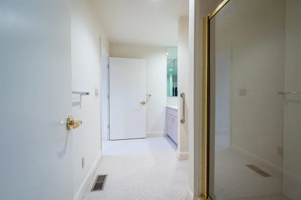a spacious bathroom with a toilet sink and a mirror