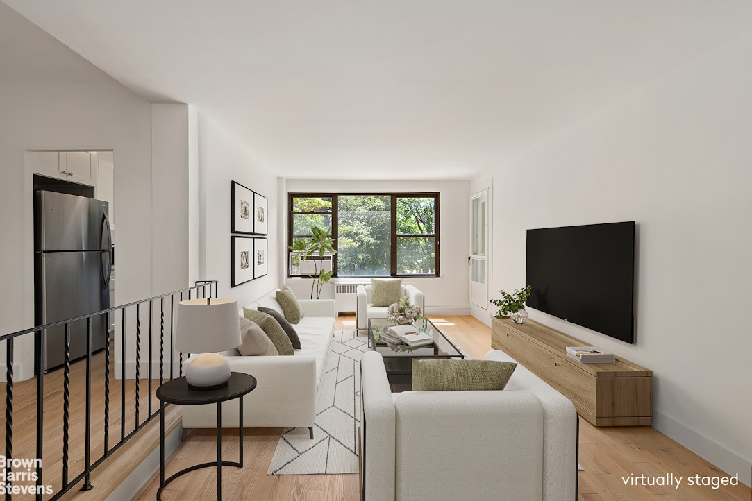 98-41 64th Road, Unit 3G Queens, NY 11374 - Photo 1 of 14 a living room with furniture and a flat screen tv
