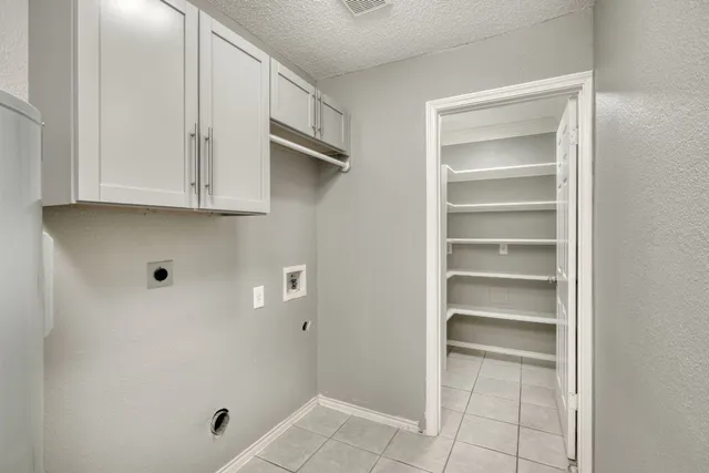 a kitchen with granite countertop a sink stove and cabinets