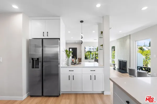 a kitchen with stainless steel appliances a refrigerator sink and stove