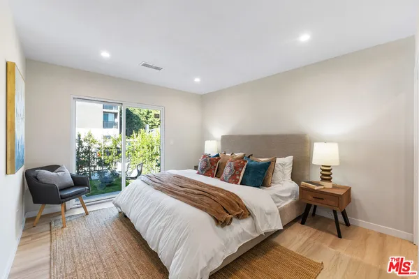 a bedroom with a bed and a chair