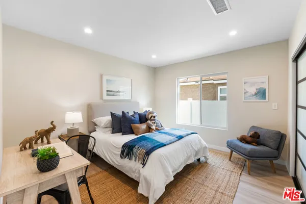 a spacious bedroom with a bed and a couch