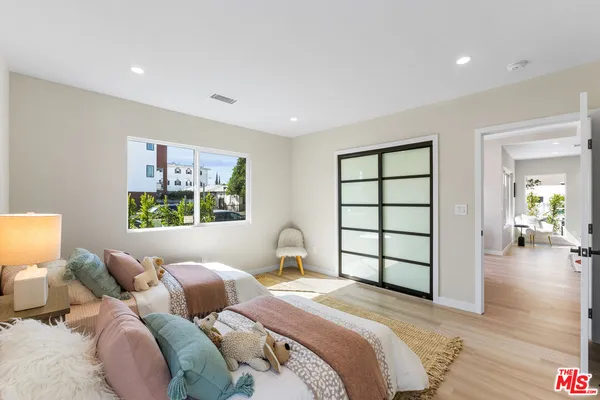 a bedroom with a bed and a painting on the wall