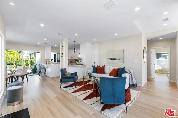 a living room with furniture and wooden floors