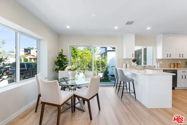 a dining room with furniture and wooden floor
