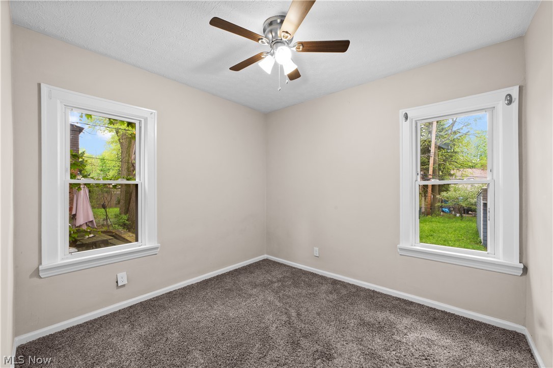 1062 Yellowstone Road Cleveland Heights, OH 44121 - Photo 13 of 29 Carpeted empty room with ceiling fan and a wealth of natural light