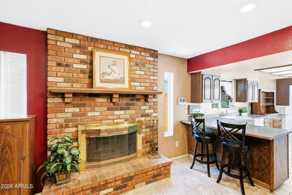 a open kitchen with granite countertop a stove and a dining table