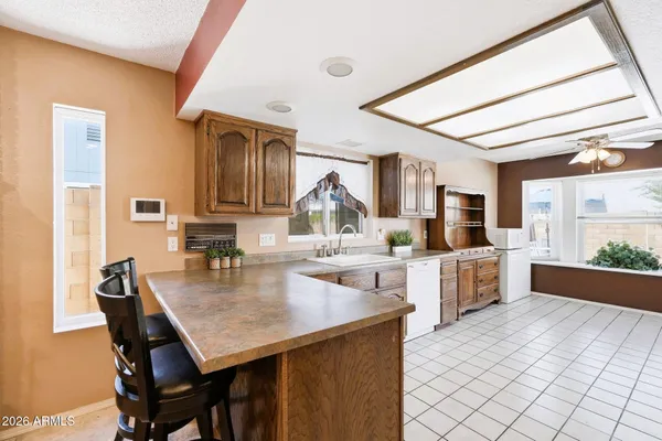 a kitchen with a table chairs and wooden floor