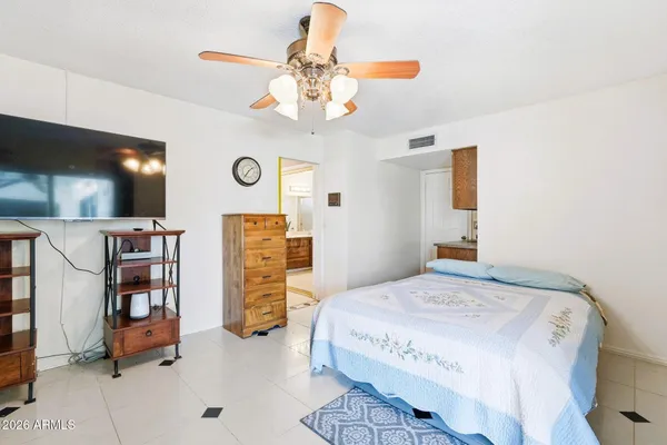 a bedroom with a bed and a chandelier
