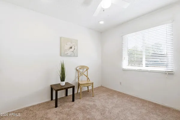 a view of a workspace with furniture and a window