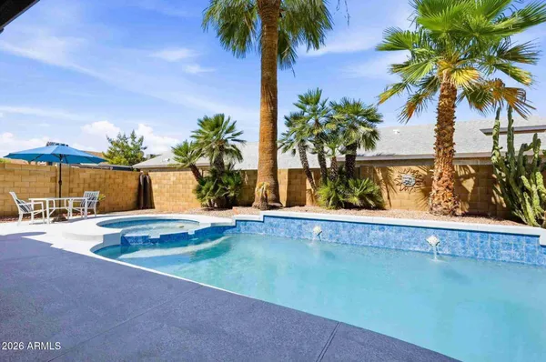 a vase of flowers sitting on a floor with a lake view
