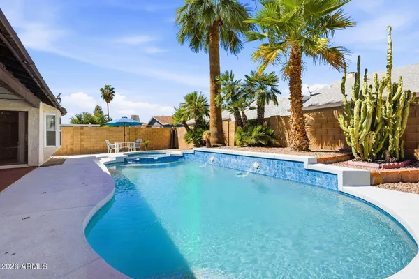 a view of a swimming pool with a yard