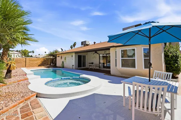 a view of a house with backyard porch and sitting area