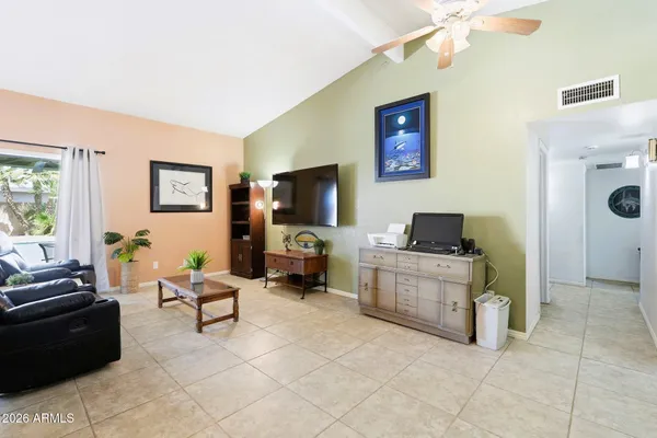 a living room with furniture and a flat screen tv
