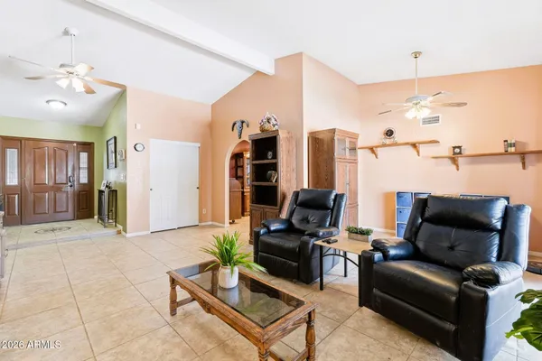 a living room with furniture and a chandelier