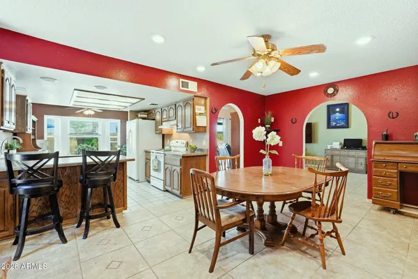 a dining room with furniture a rug and a large window