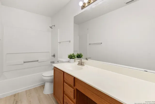 a bathroom with a sink a toilet and bathtub