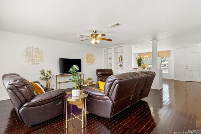 a living room with furniture and wooden floor