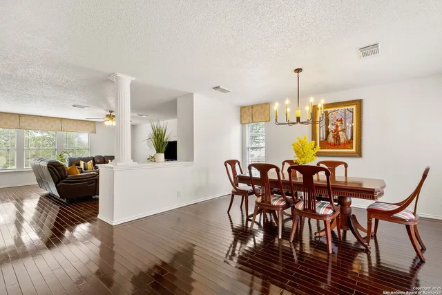 a view of a dining room with furniture and wooden floor