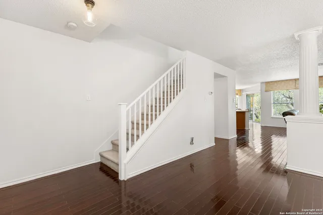 a view of entryway and hall with wooden floor