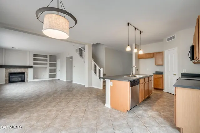 a kitchen with stainless steel appliances granite countertop a stove oven and a refrigerator
