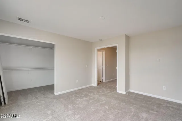 a view of an empty room and closet area