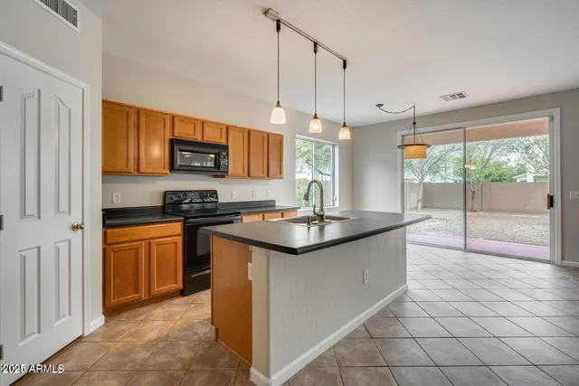 a kitchen with stainless steel appliances granite countertop a sink and a stove