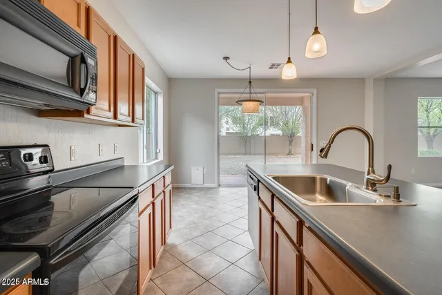 a kitchen with stainless steel appliances granite countertop a sink and a stove