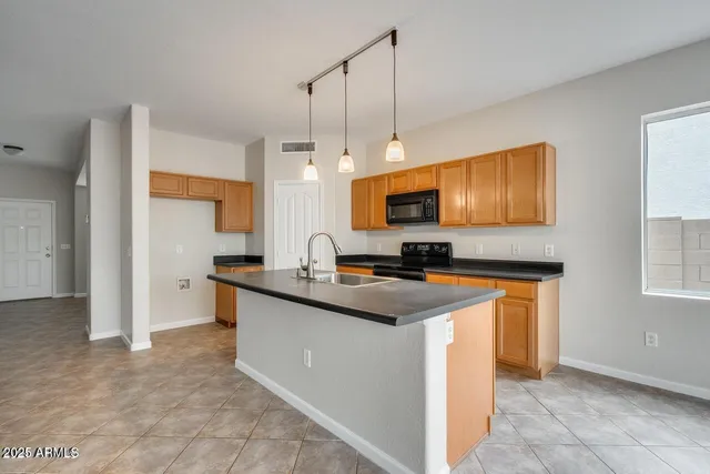 a kitchen with stainless steel appliances a stove sink microwave and refrigerator
