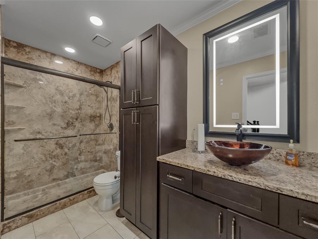 2317 Wellesly Road Rowlett, TX 75089 - Photo 31 of 39 a bathroom with a granite countertop sink a toilet and mirror