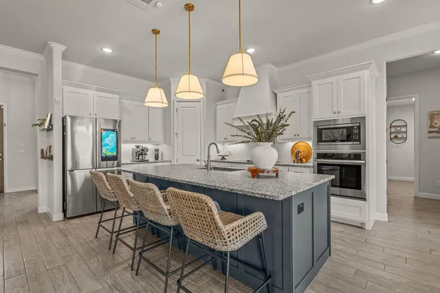 a kitchen with a sink stove and cabinets