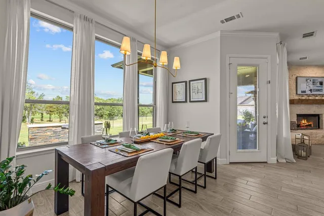 a spacious bedroom with a bed and a chandelier