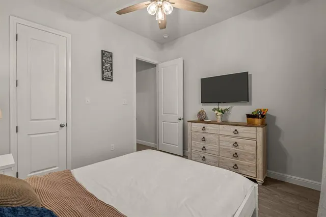 a bathroom with a granite countertop sink a toilet and a mirror
