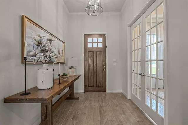 a room with wall paintings and a window