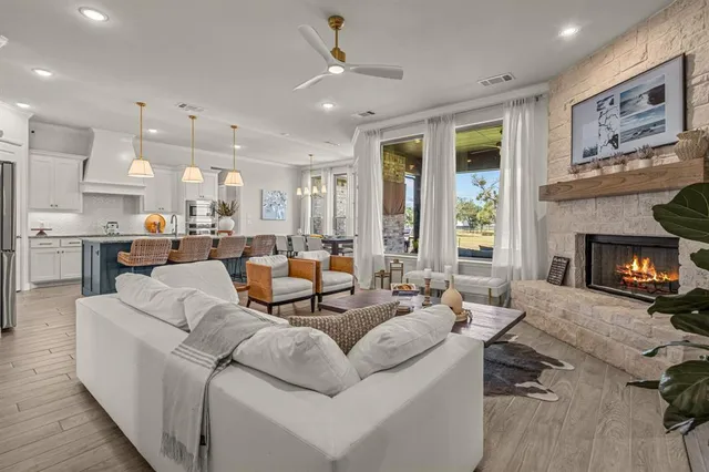 a living room with furniture kitchen view and a fireplace