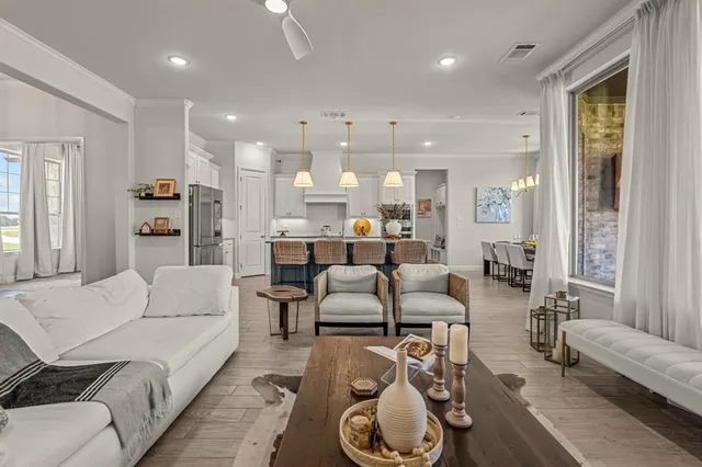 a view of kitchen and dining area with furniture window and wooden floor