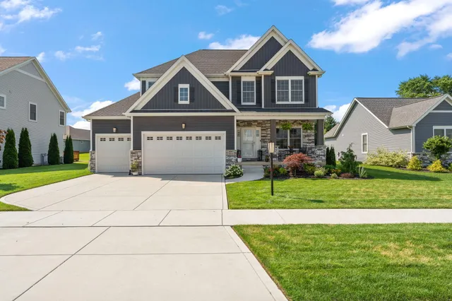 a front view of a house with a yard and garage