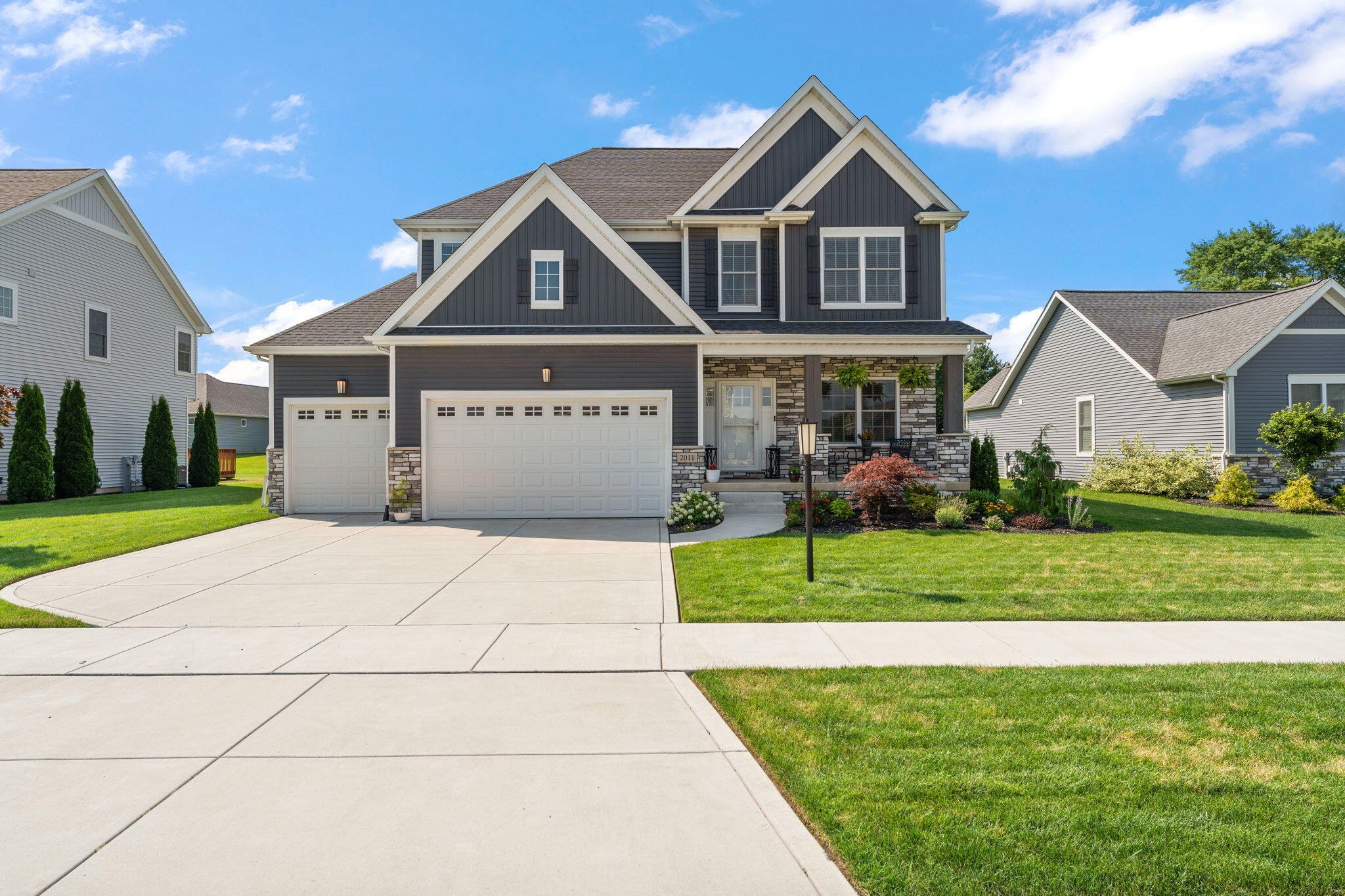 a front view of a house with a yard and garage