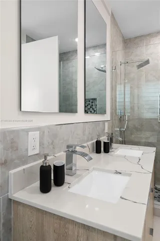 a bathroom with a granite countertop sink a toilet and bathtub