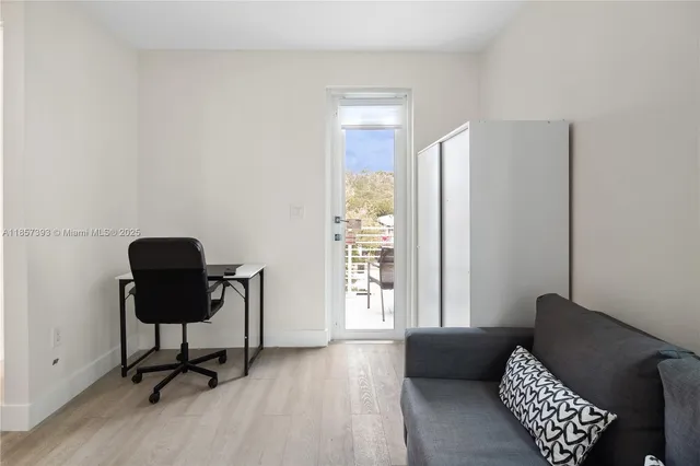 a room with two bed and a night stand