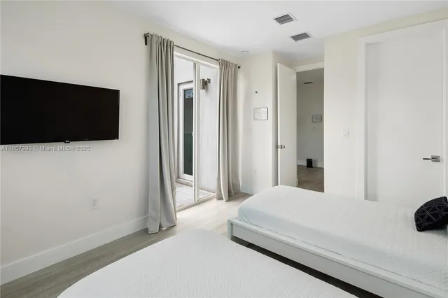 a bedroom with a bed and a flat screen tv