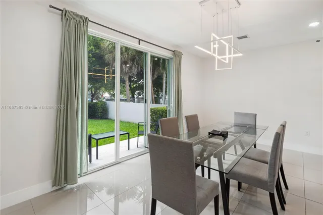 a bedroom with a bed and a flat tv screen on a dresser