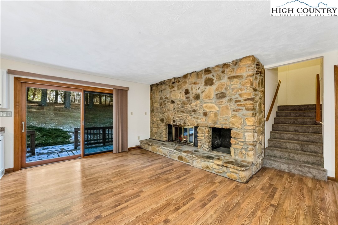 1324 Ripshin Road Troutdale, VA 24378 - Photo 19 of 47 a view of an empty room with wooden floor and a fireplace