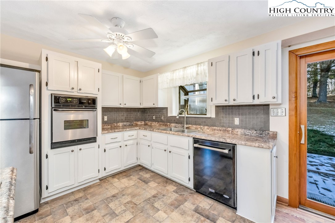 1324 Ripshin Road Troutdale, VA 24378 - Photo 23 of 47 a kitchen with granite countertop white cabinets and white appliances