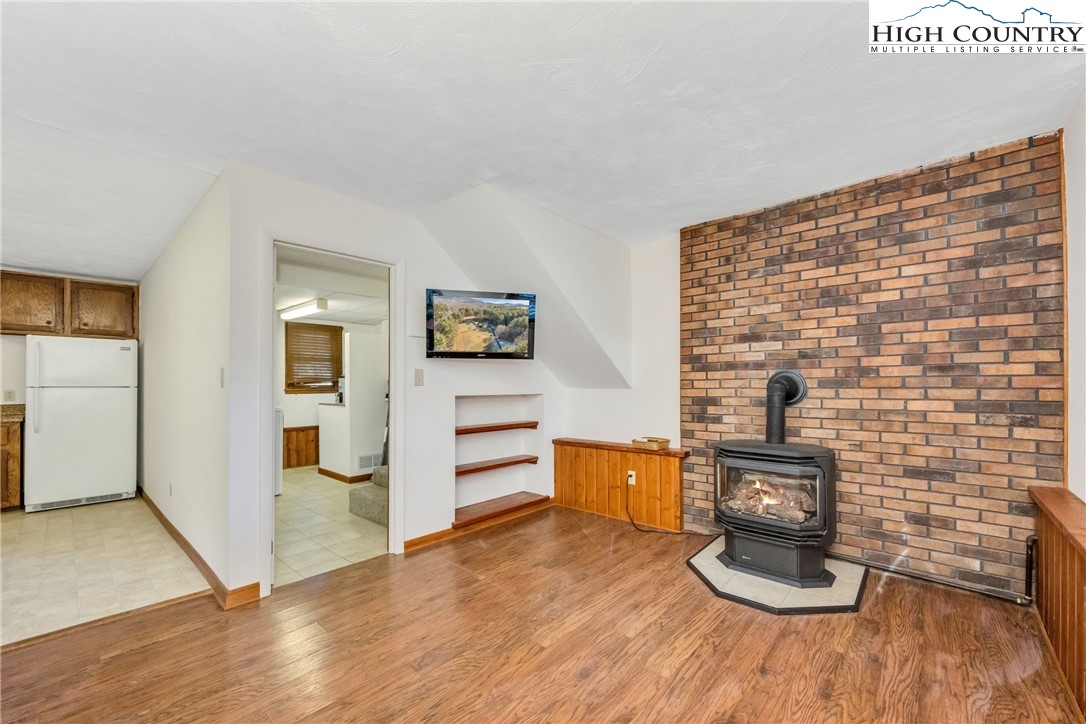 1324 Ripshin Road Troutdale, VA 24378 - Photo 25 of 47 a kitchen with granite countertop a stove and a wooden floor