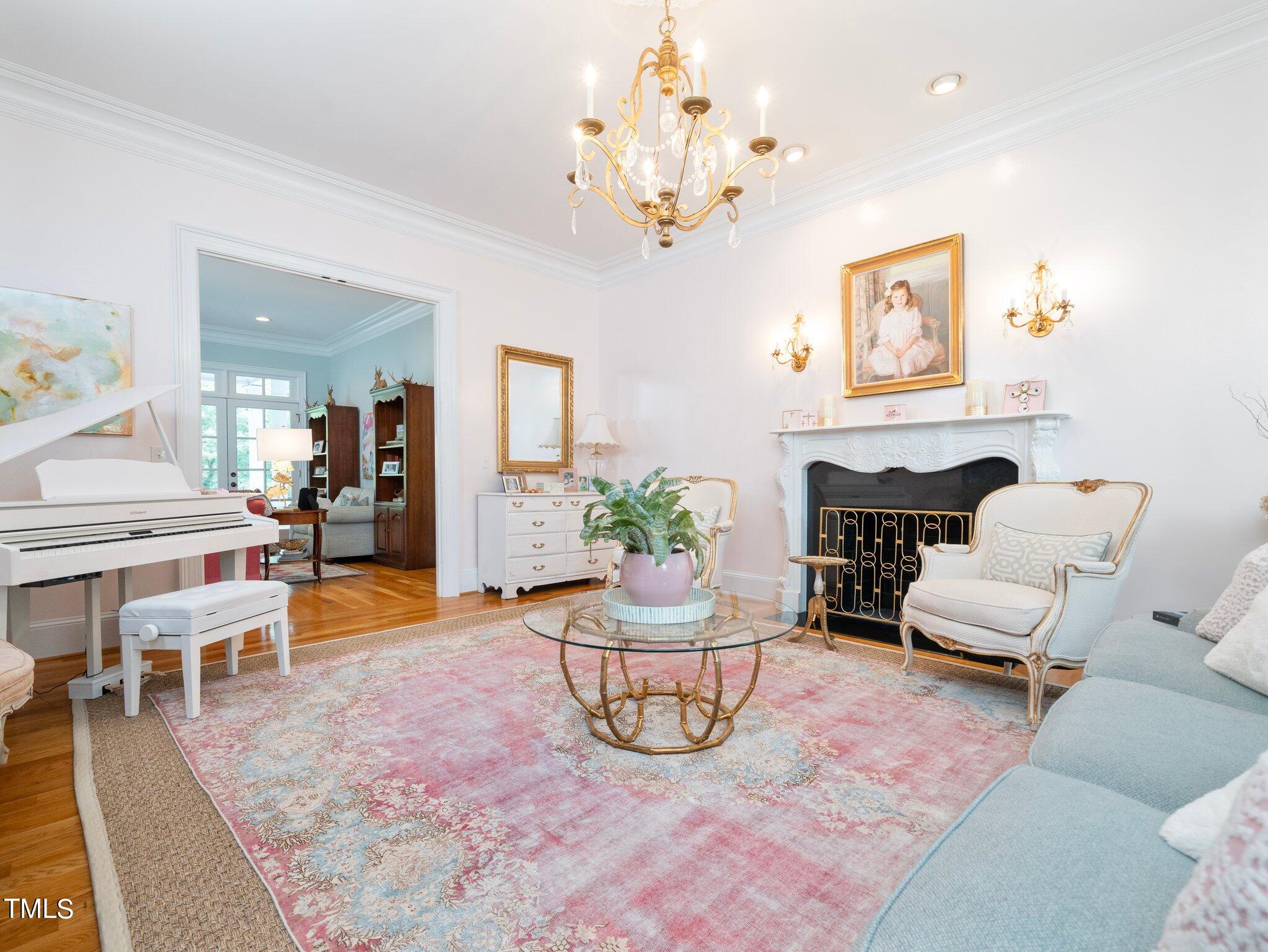 2512 Lewiswood Lane Raleigh, NC 27608 - Photo 13 of 41 a living room with furniture and a chandelier