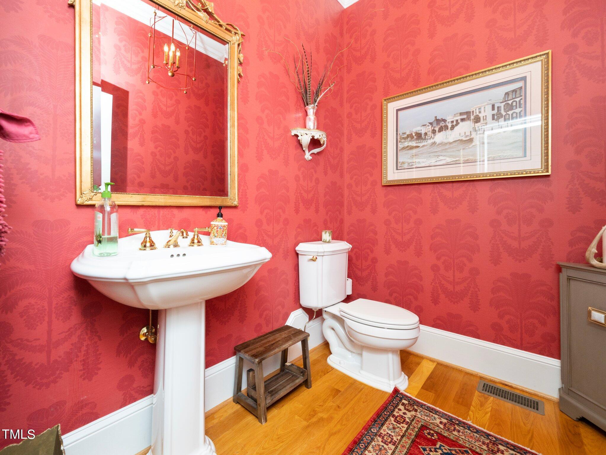 2512 Lewiswood Lane Raleigh, NC 27608 - Photo 15 of 41 a bathroom with a sink a toilet and mirror