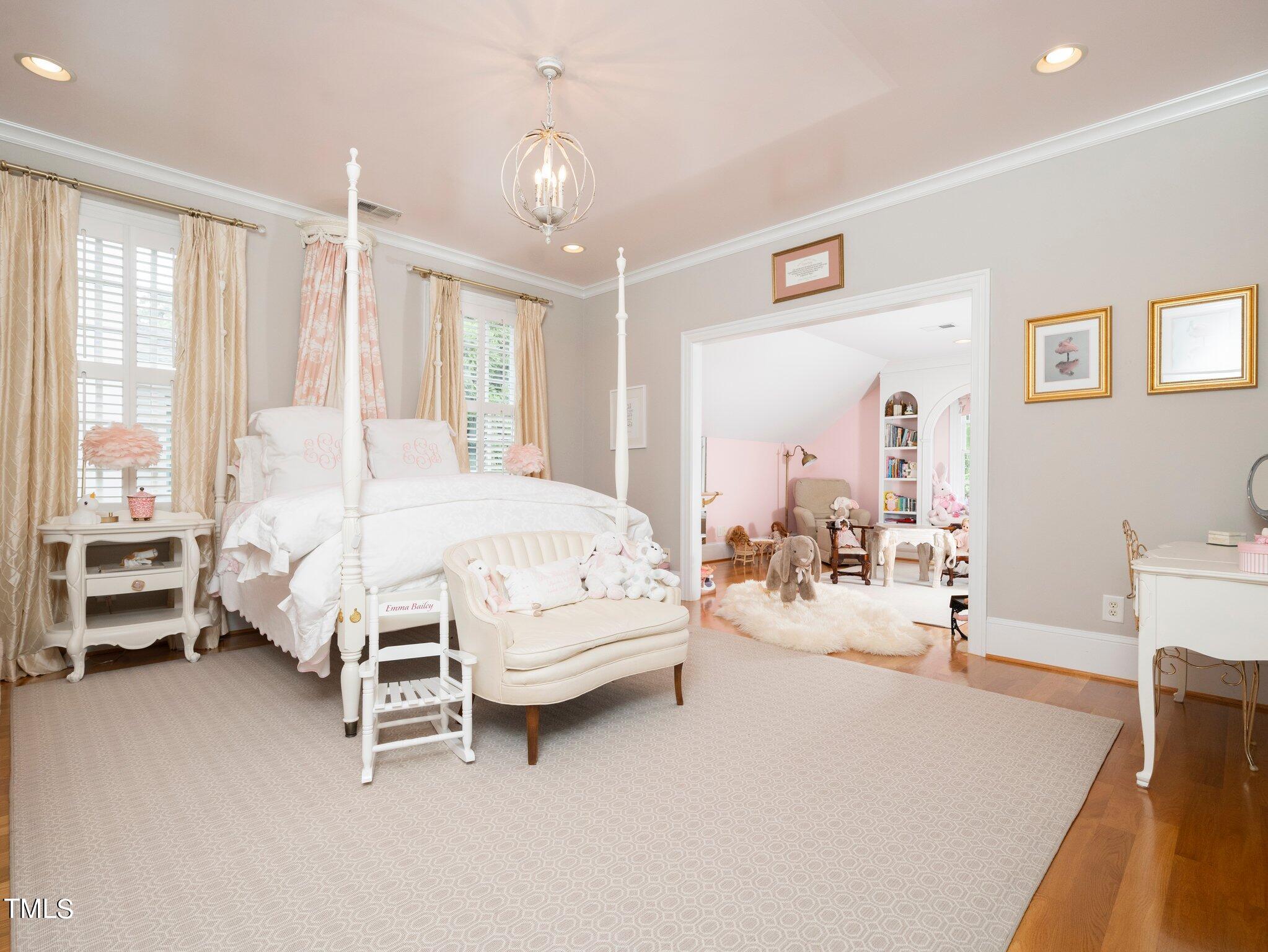 2512 Lewiswood Lane Raleigh, NC 27608 - Photo 21 of 41 a bedroom with furniture and a chandelier