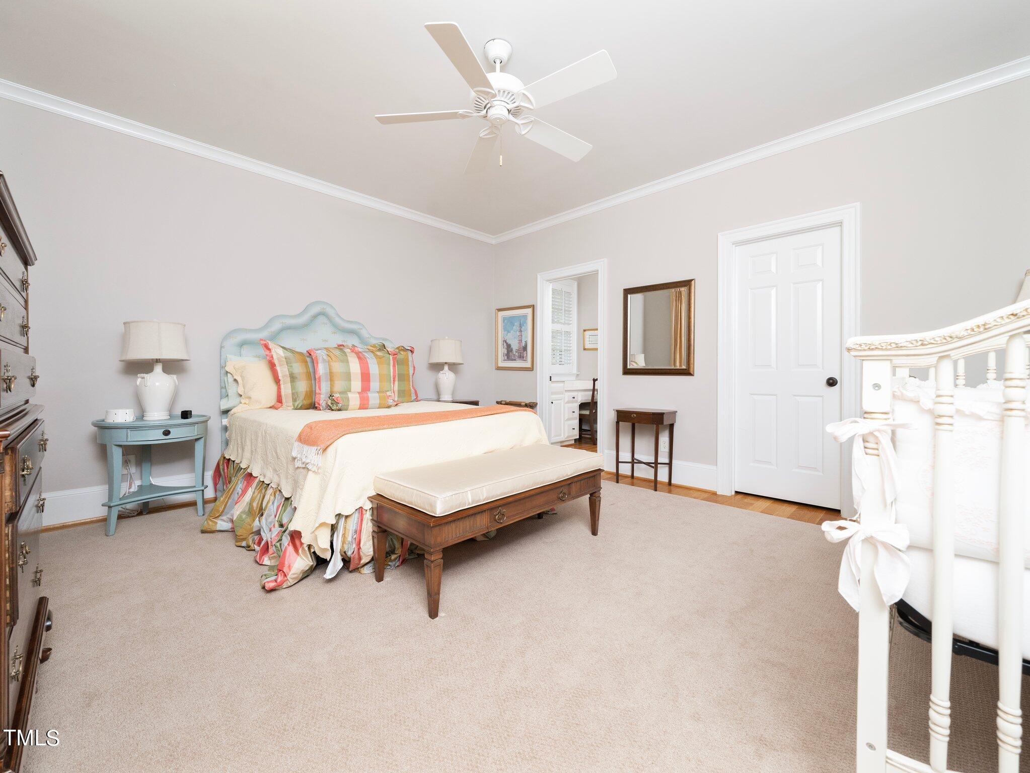 2512 Lewiswood Lane Raleigh, NC 27608 - Photo 24 of 41 a spacious bedroom with a bed and a chandelier