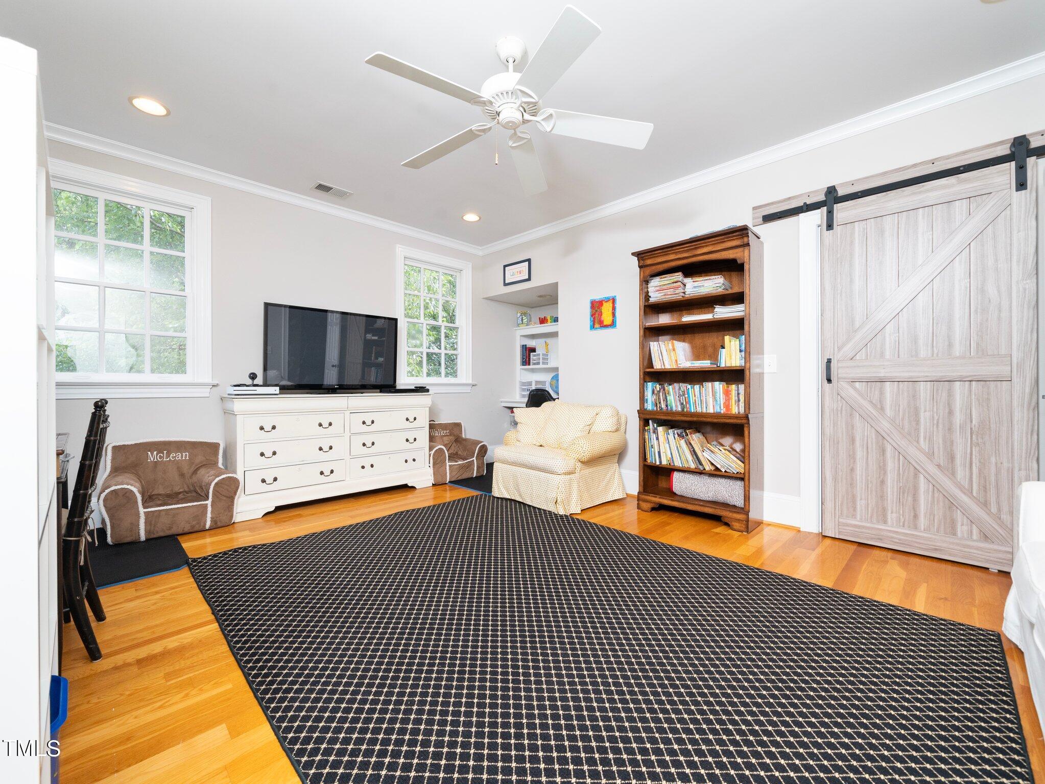 2512 Lewiswood Lane Raleigh, NC 27608 - Photo 28 of 41 a bedroom with furniture and a flat screen tv